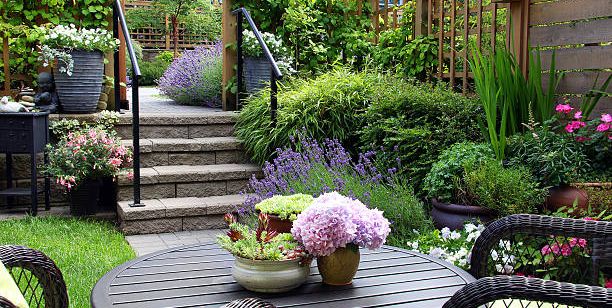 A garden full with flowers and chair and table