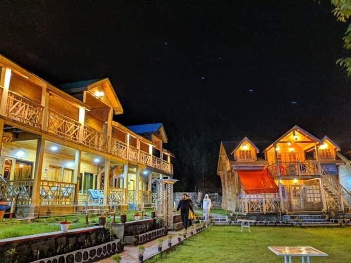 Night view of Swiss Wood Cottages and lawn