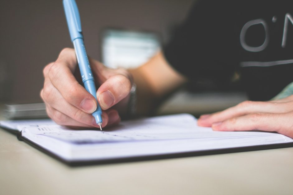 a person writing on a paper