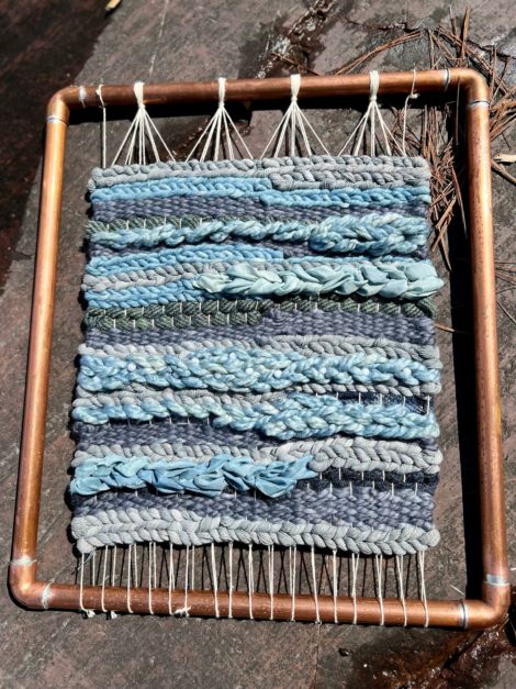 Blue and white coloured woven wall hanging