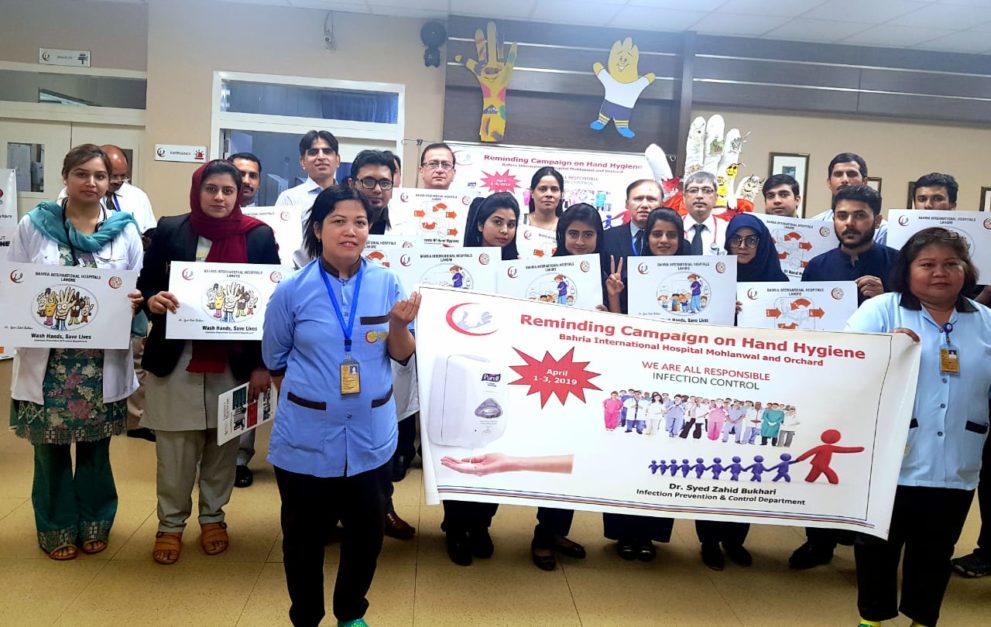 hospital staff holding banners for awareness regarding infection prevention