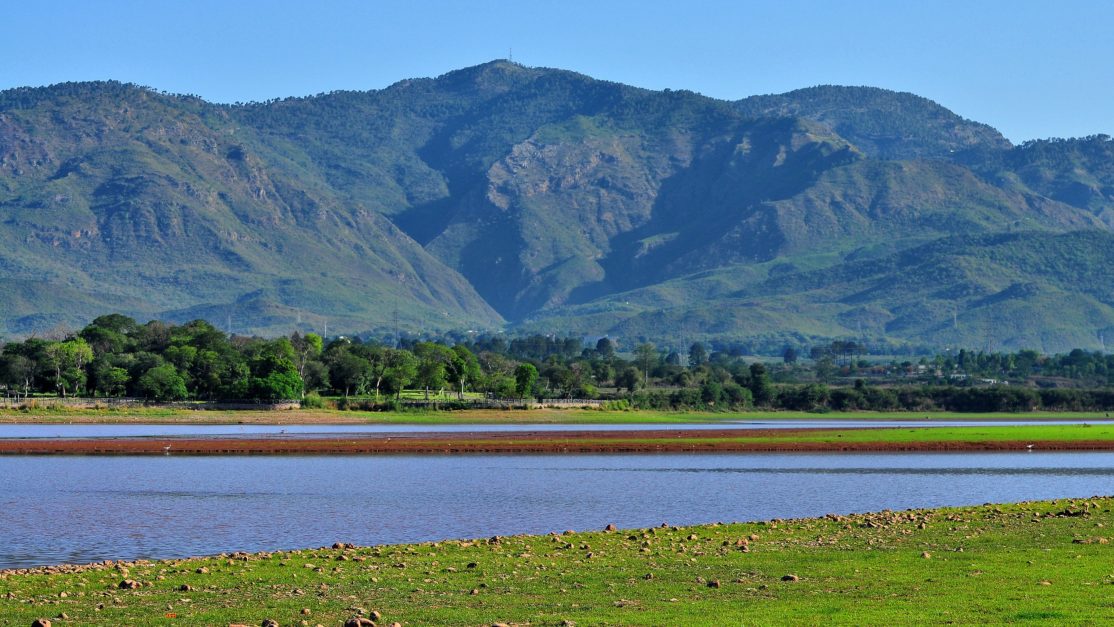 rawal dam lake with mountains in the rear view