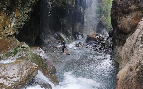 A boy enjoying in Umbrella Waterfall near murree