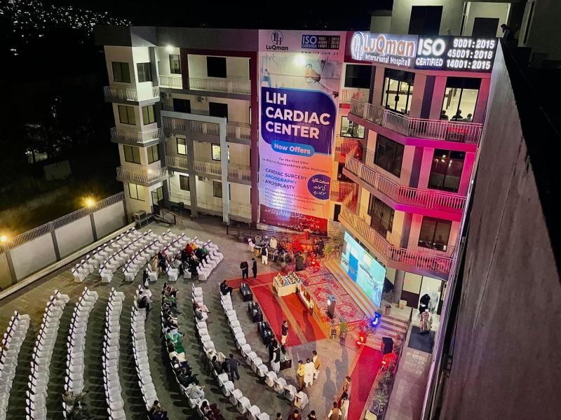 A night view of Luqman Hospital Swat with people seated for ceremony