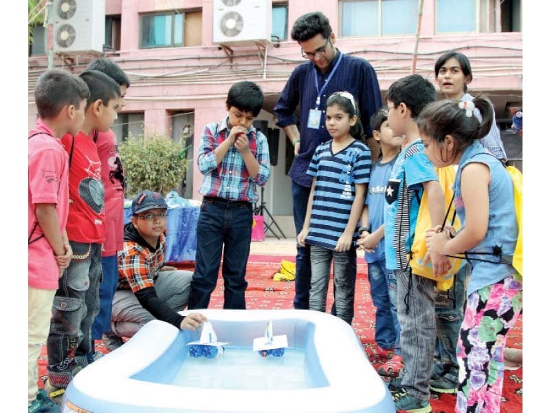 Instructor guiding young children at summer camp