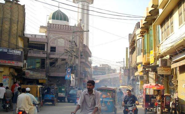 People hustling and bustling in the street of Gujrat