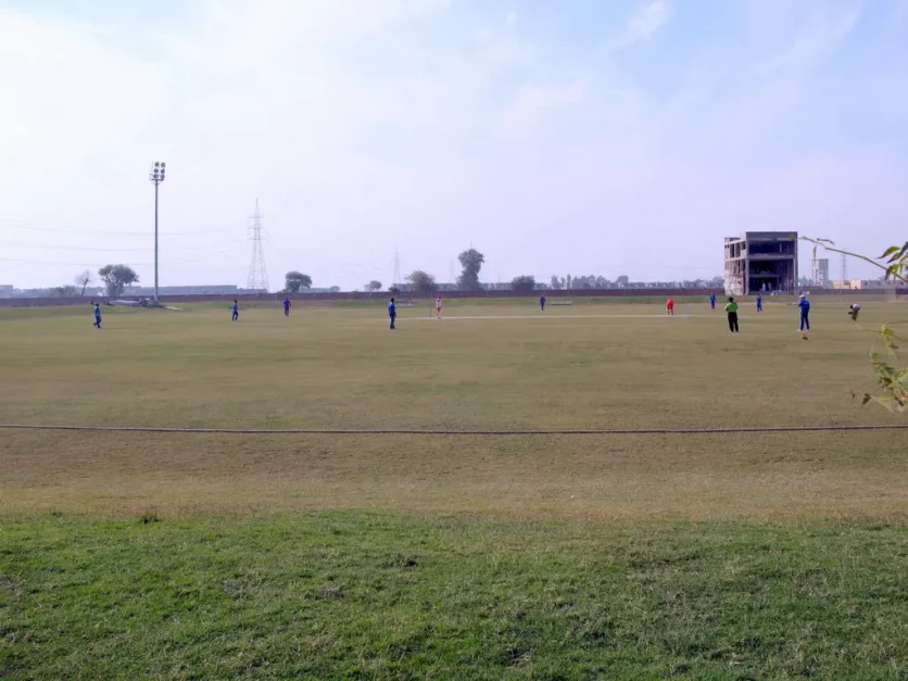 People playing cricket in Khayaban-e-Amin Cricket Stadium