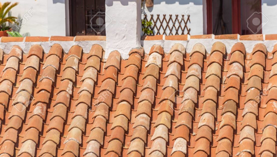 old traditional Spanish tiles on the roof of a building