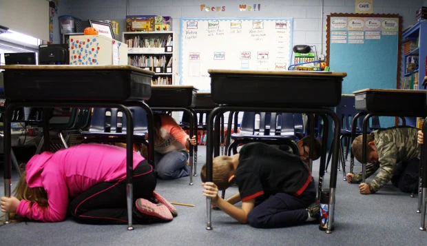 Kids hiding under school tables during earthquake