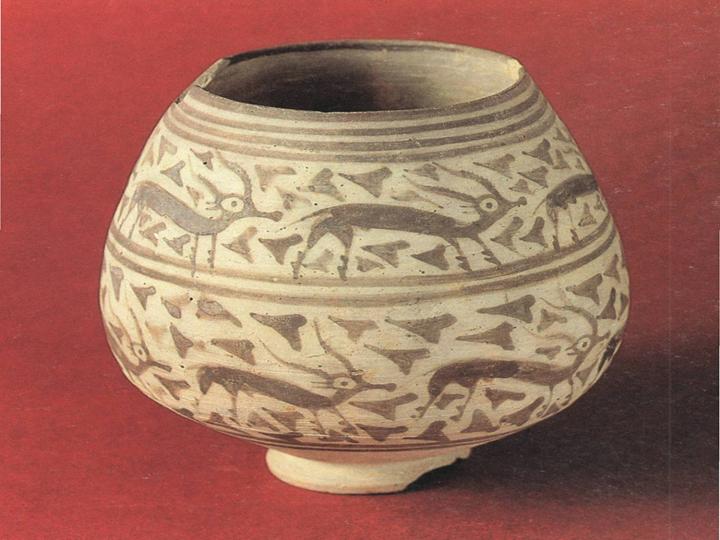 hand made pot with image of deers carved on it