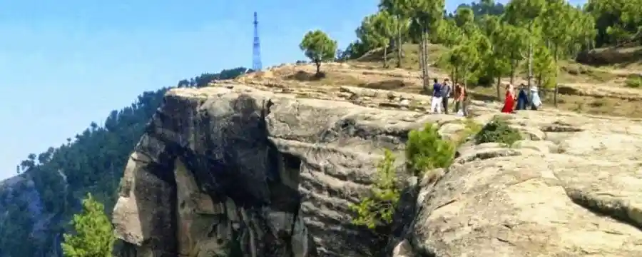 people standing on cliff of poanjpeer rock