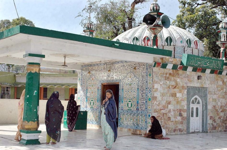 some women standing outside the bari imam building