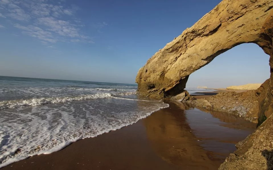 sapat beach and a gaint curved stone in the middle of the water