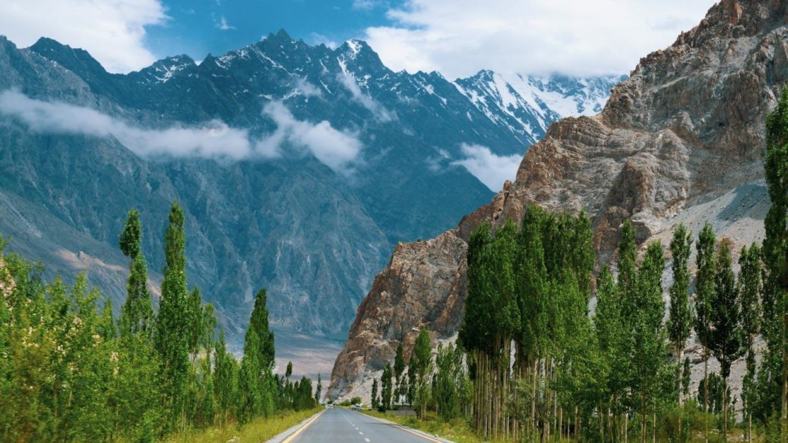 majestic mountain with a road and trees 