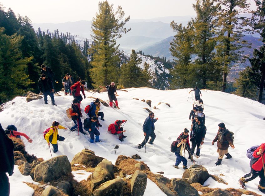 people trekking to ganga choti in snow covered tracks