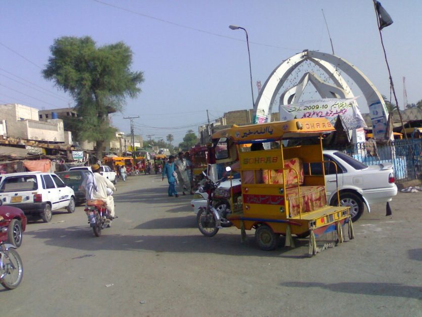 Vehicles moving around roundabout in Naushahro Feroze