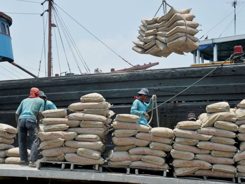 Workers loading and unloading askari cement bags