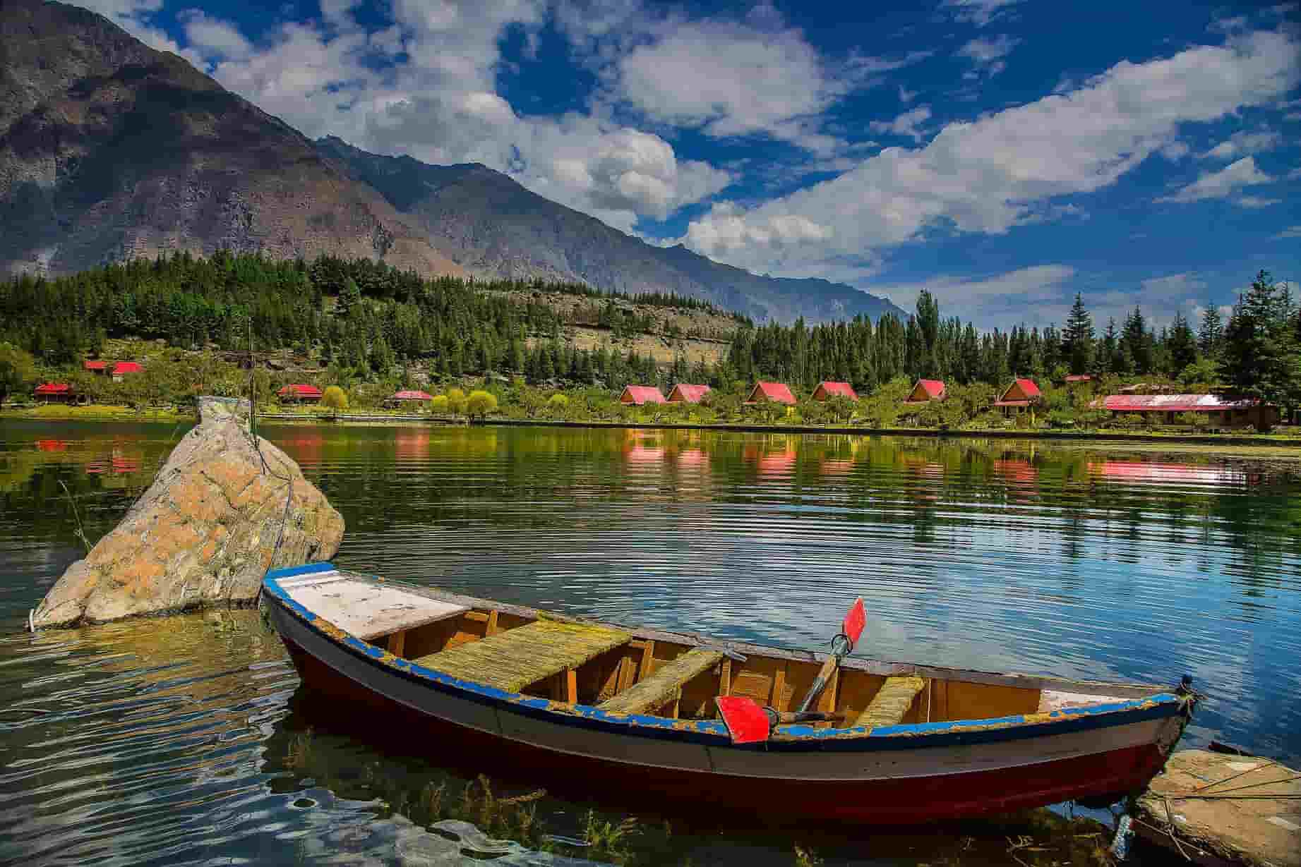 a boat in Upper Kachura Lake with mountains in the rear view