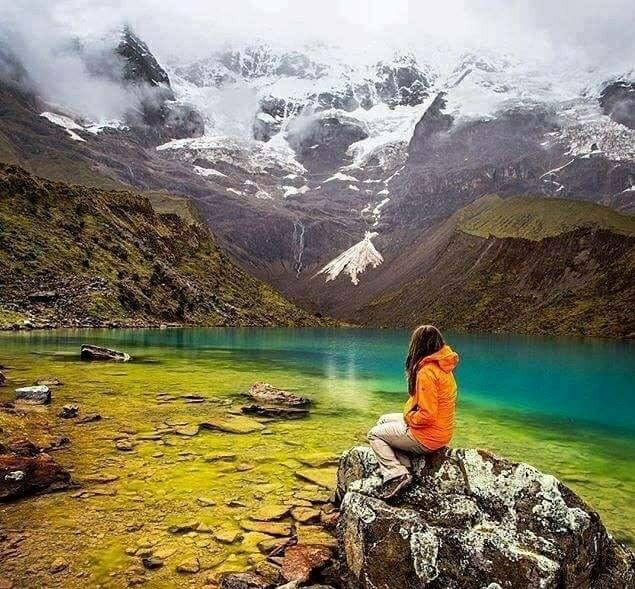 a girl sitting on a rock at rama lake 