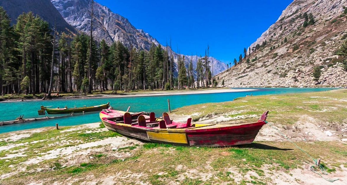 a boat is parked near lake 