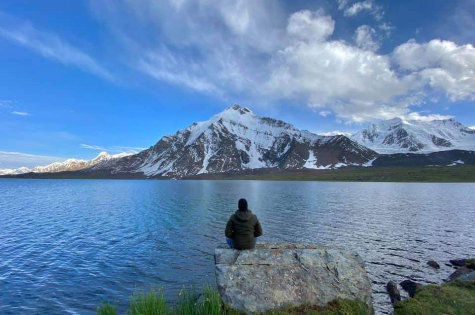 A man sitting infront of Karambar Lake