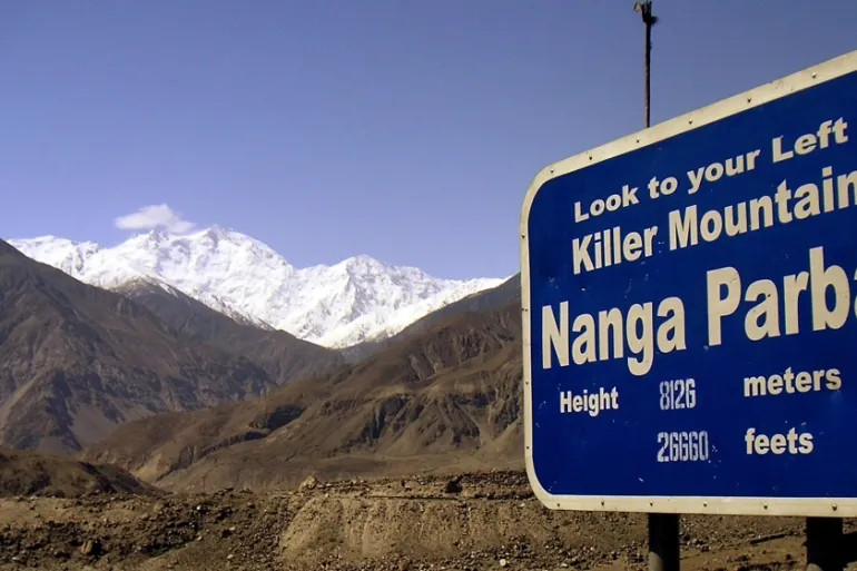 Nanga parbat name plate and the mountain itself in the background