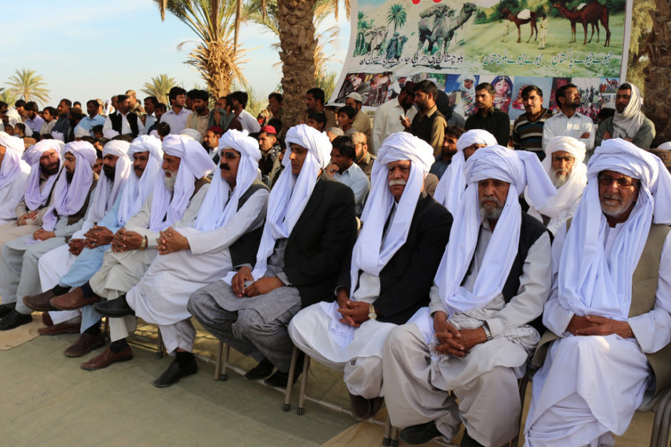 Balochi people in balochi topi sitting on Baloch culture day