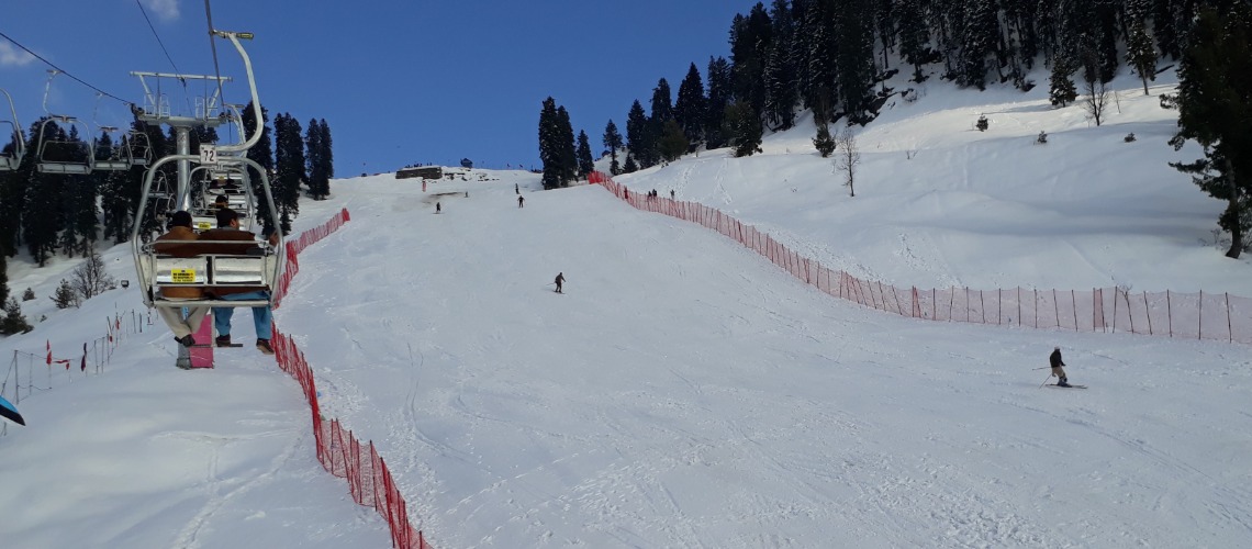 Tourist riding on chair lift at Malam Jabba Ski Resort