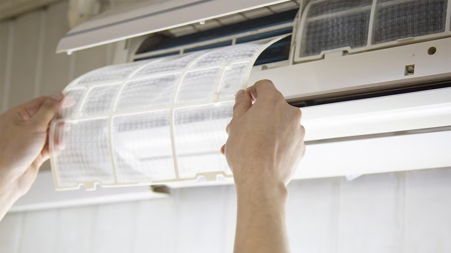 A person changing AC filter