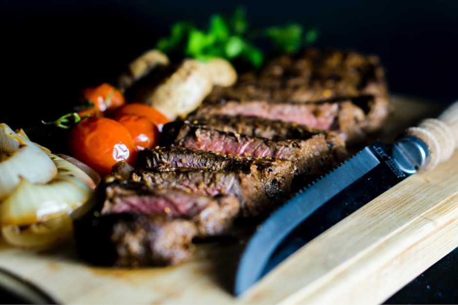 steak on wooden plate with cherry tomatoes