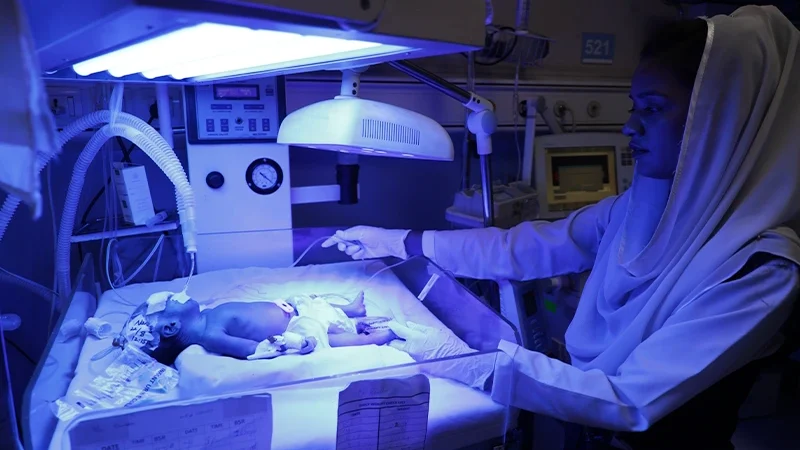 A nurse monitoring a newborn 