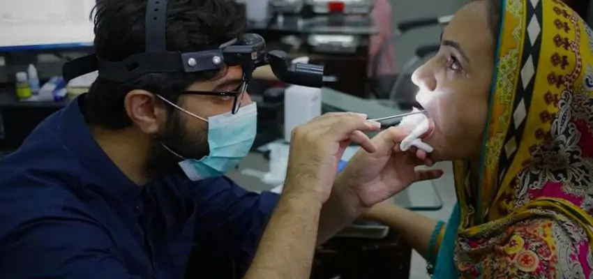 an ENT specialist examining the patient 