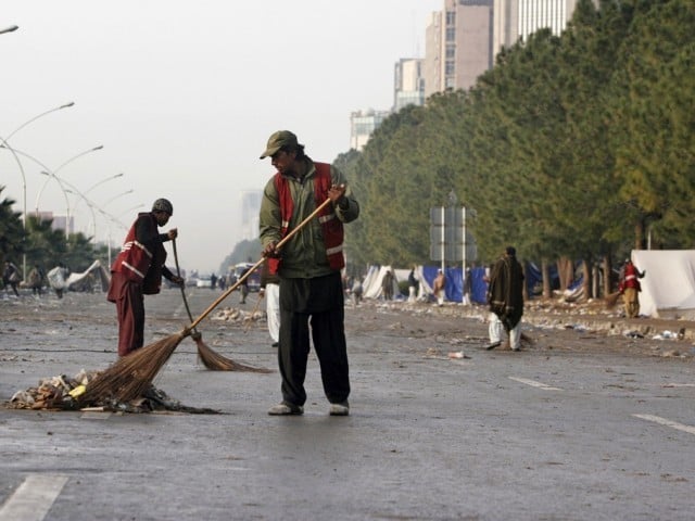 Workers cleaning the road