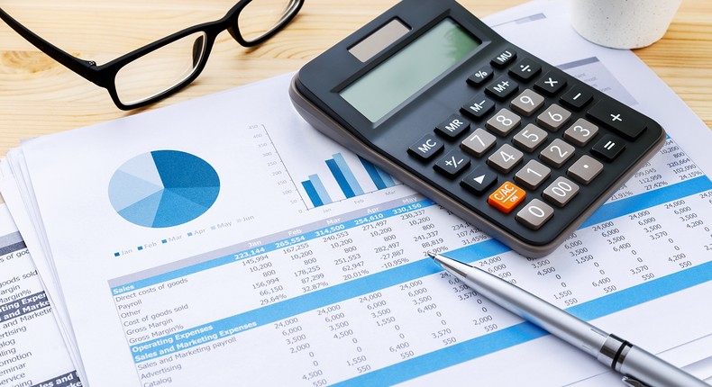 calculator pen charts and glasses to potray budget planning